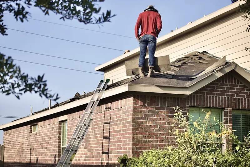Professional roofer working on a residential roof in Rolling View